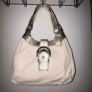 Elegant Cream and Gold Women's Coach handbag